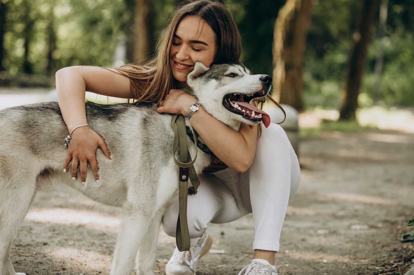 A woman embracing her rescued husky